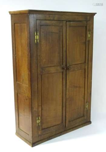 A late 18thC oak wardrobe with a moulded cornice above