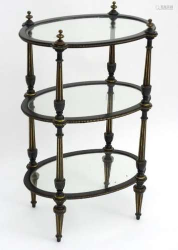 A late 19thC ebonised three tier whatnot with glazed