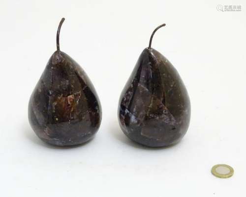A pair of purple glass pear shaped items, each