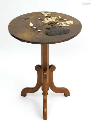 An early 20thC Japanese elm tripod table with mounted