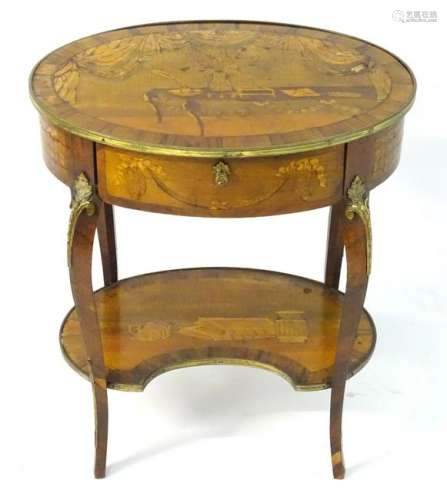 A 19thC French centre table with an oval top and brass