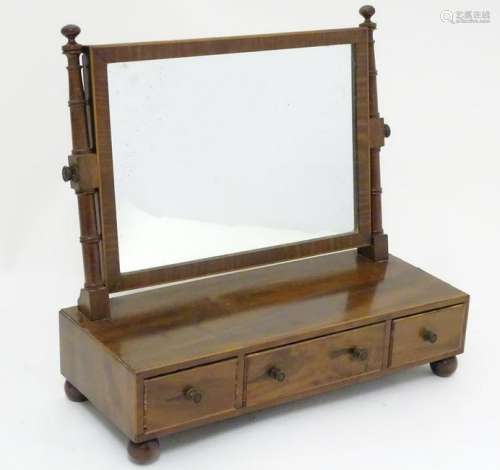 A Victorian mahogany toilet mirror with turned supports