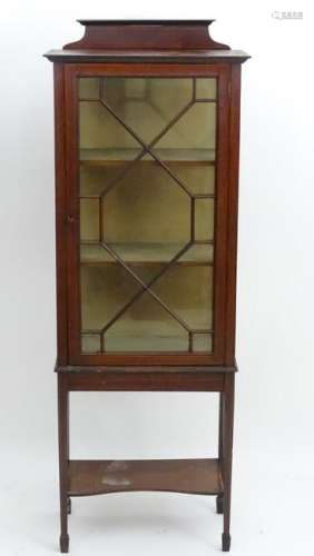 An early 20thC mahogany display cabinet with a raised