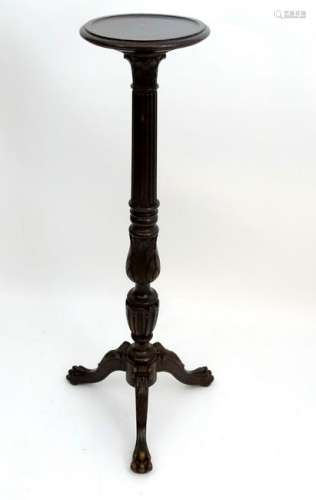 An early 20thC oak Edwards & Roberts torchiere with a
