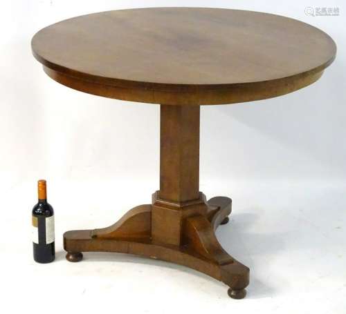 A mid / late 19thC mahogany tilt top table with a
