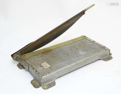 An old mid-century paper cutter also sometimes