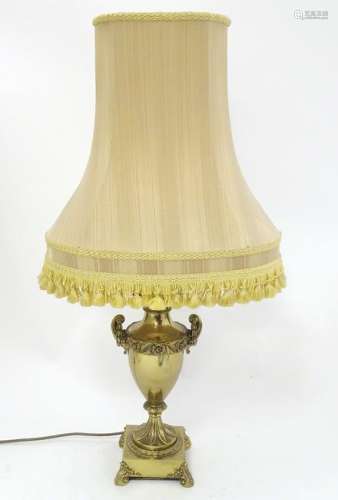 A 1970's mid-century modern urn shaped brass lamp with