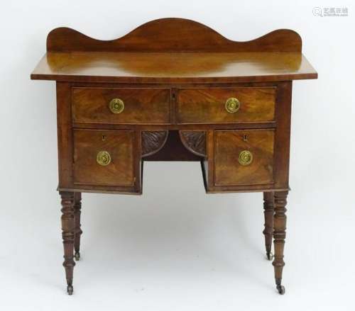 A mid / late 19thC mahogany lowboy with a bow fronted
