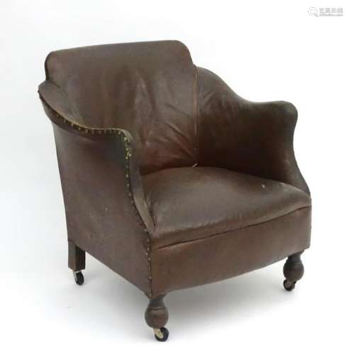 An early / mid 20thC armchair with brass stud