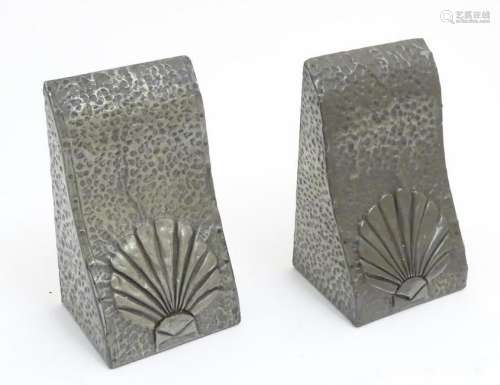 Art Nouveau: a pair of shaped and hand hammered pewter