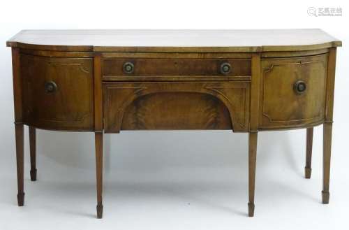 An early 20thC mahogany bow fronted sideboard, having