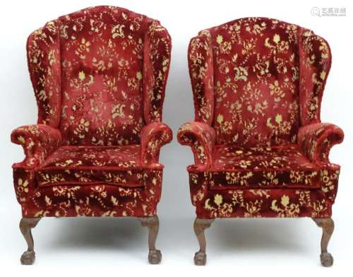 A his and hers pair of mid 20thC wingback armchairs