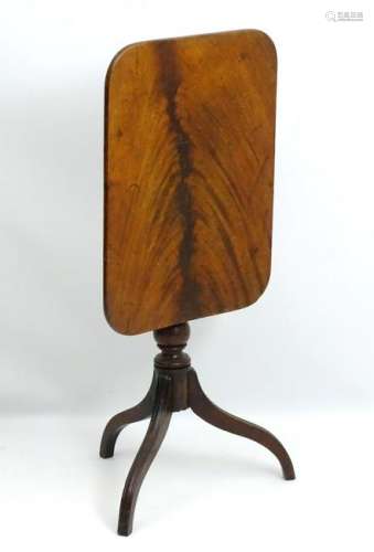 An early 19thC mahogany tripod table with a turned