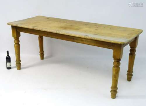 A late 19thC / early 20thC pine kitchen table standing