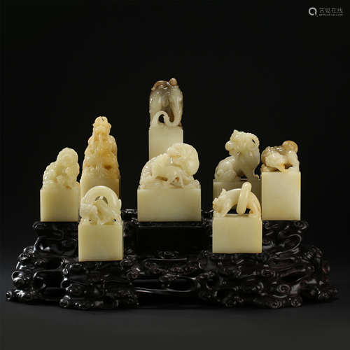 EIGHT CHINESE YELLOW JADE BEAST SEALS ON ROSEWOOD BASE